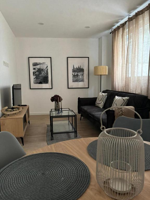 a living room with a couch and a table at VTZ Los Balcones del Casco in Zaragoza