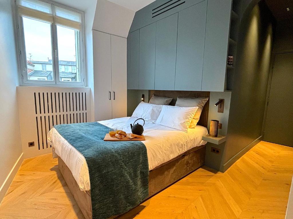 - une chambre avec un grand lit et une armoire bleue dans l'établissement Le Loft Tour Eiffel, à Paris