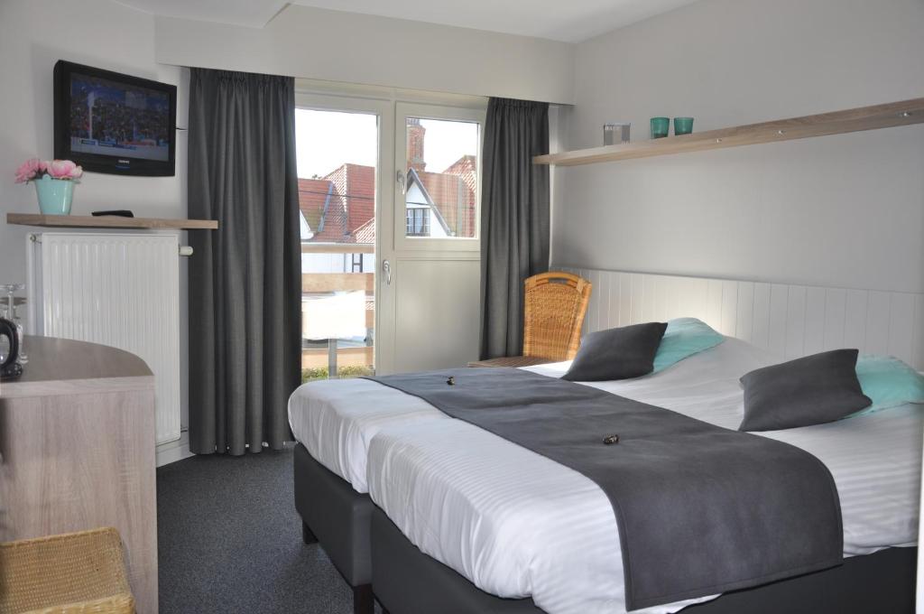 Postel nebo postele na pokoji v ubytování Hotel Bilderdijk
