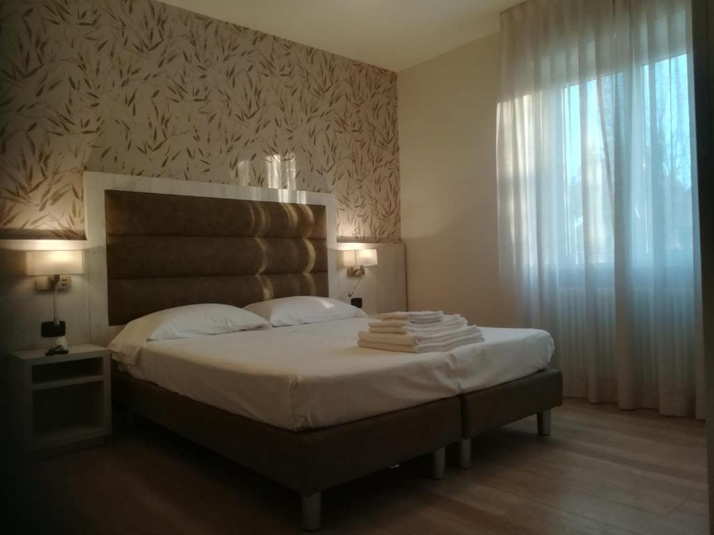 Postel nebo postele na pokoji v ubytování Hotel Miramare