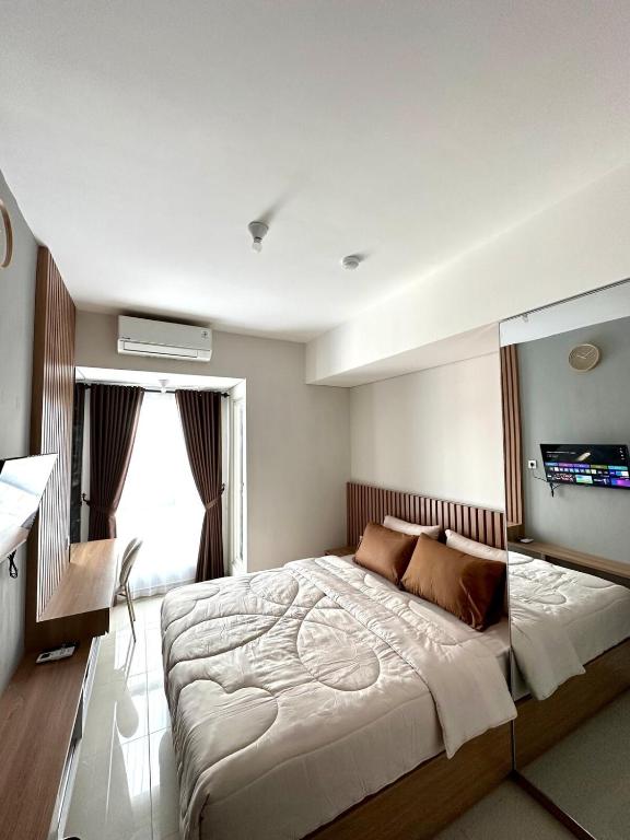 a bedroom with a large bed in a room at Barsa City by Eleanor in Seturan