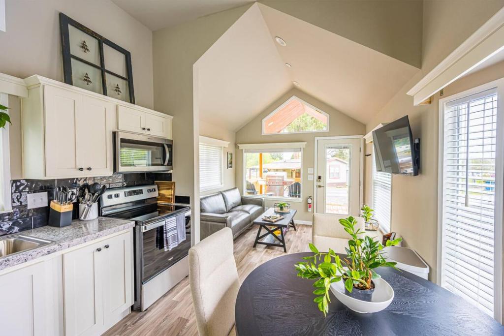 a kitchen with a table and a dining room at Rainforest Tiny Home Retreat Farm House in Forks