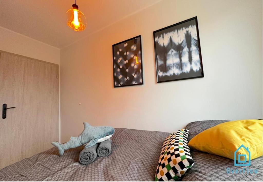 a bedroom with a bed and two pictures on the wall at Shark Room - 3 km to Baltic Sea in Gdańsk