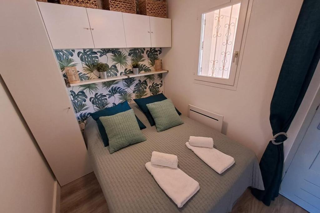 Cette petite chambre comprend un lit avec deux oreillers. dans l'établissement Apartment 300 m from Saint-Clair beach, au Lavandou