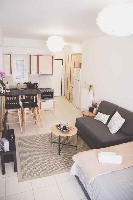a living room with a couch and a kitchen at Ιasonas Apartment in Nafplio