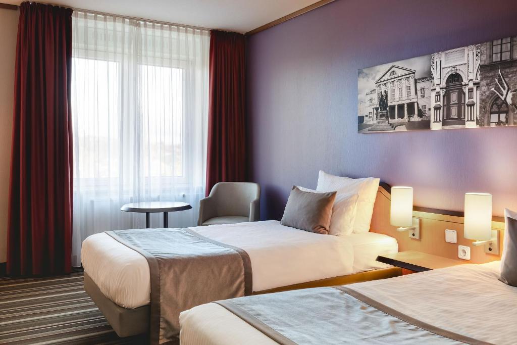 Voodi või voodid majutusasutuse Leonardo Hotel Weimar toas