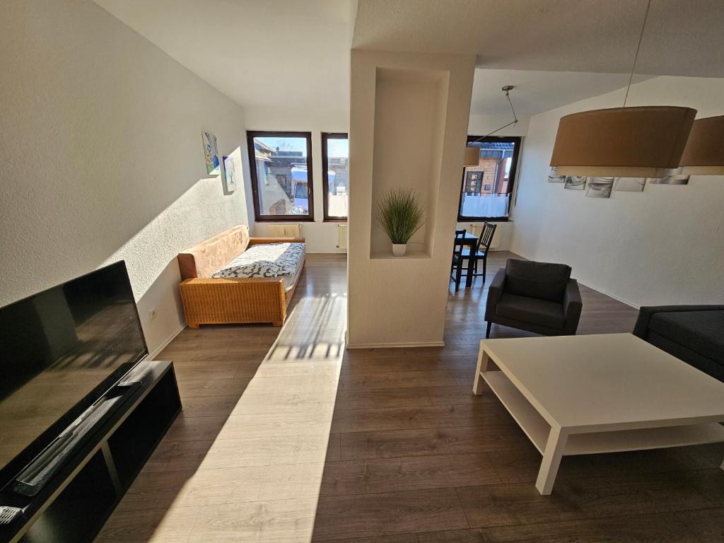 a living room with a couch and a table at Gepflegte Monteurswohnung in Rommerskirchen in Rommerskirchen