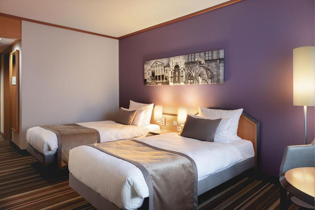 Voodi või voodid majutusasutuse Leonardo Hotel Weimar toas