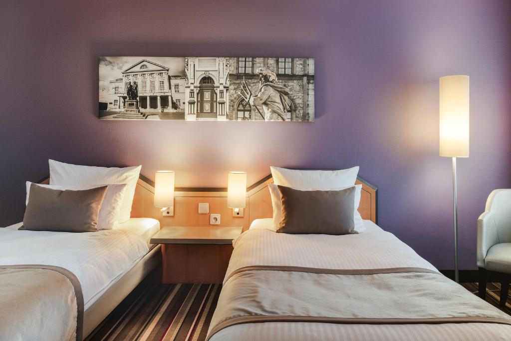 Voodi või voodid majutusasutuse Leonardo Hotel Weimar toas