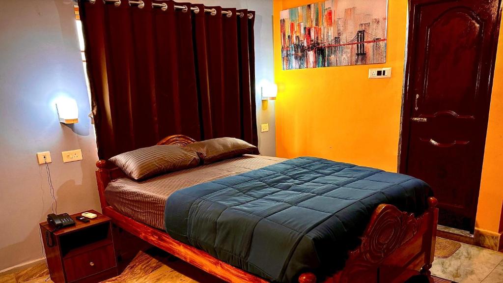 a bedroom with a bed in a room at Dee Dash Inn in Bhubaneshwar