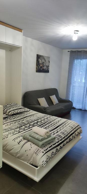 une chambre avec un grand lit et un canapé dans l'établissement Studio a proximité de Paris et Orly, à Chevilly-Larue