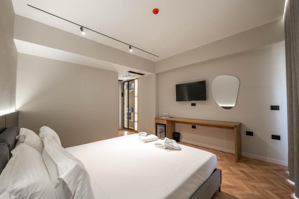 Postel nebo postele na pokoji v ubytování Sasso Hotel