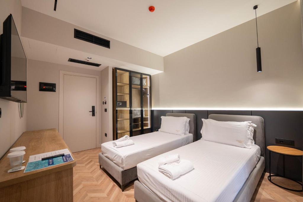 Postel nebo postele na pokoji v ubytování Sasso Hotel