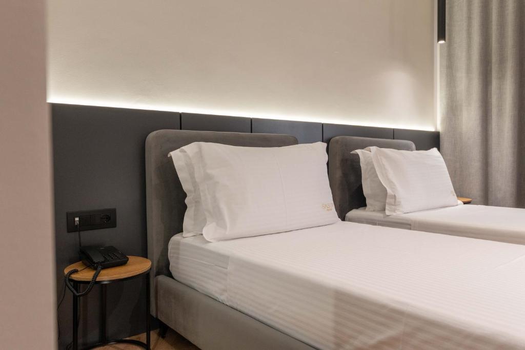 Postel nebo postele na pokoji v ubytování Sasso Hotel