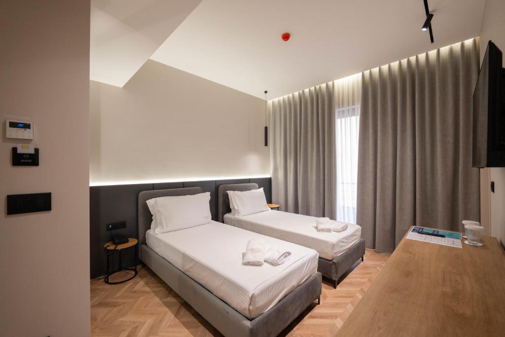 Postel nebo postele na pokoji v ubytování Sasso Hotel