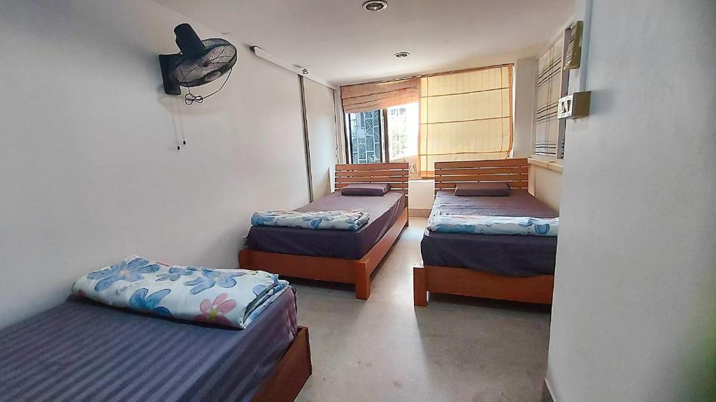 Postel nebo postele na pokoji v ubytování KingSun HOSTEL 金珊旅馆