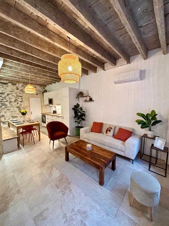 un salon avec un canapé et une table dans l'établissement Jolie maison en centre ville avec climatisation grand lit double, à Arles