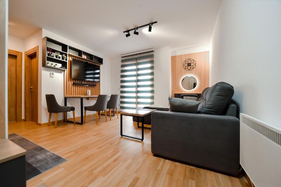 a living room with a couch and a table at Gorski Elegance 1 in Zlatibor