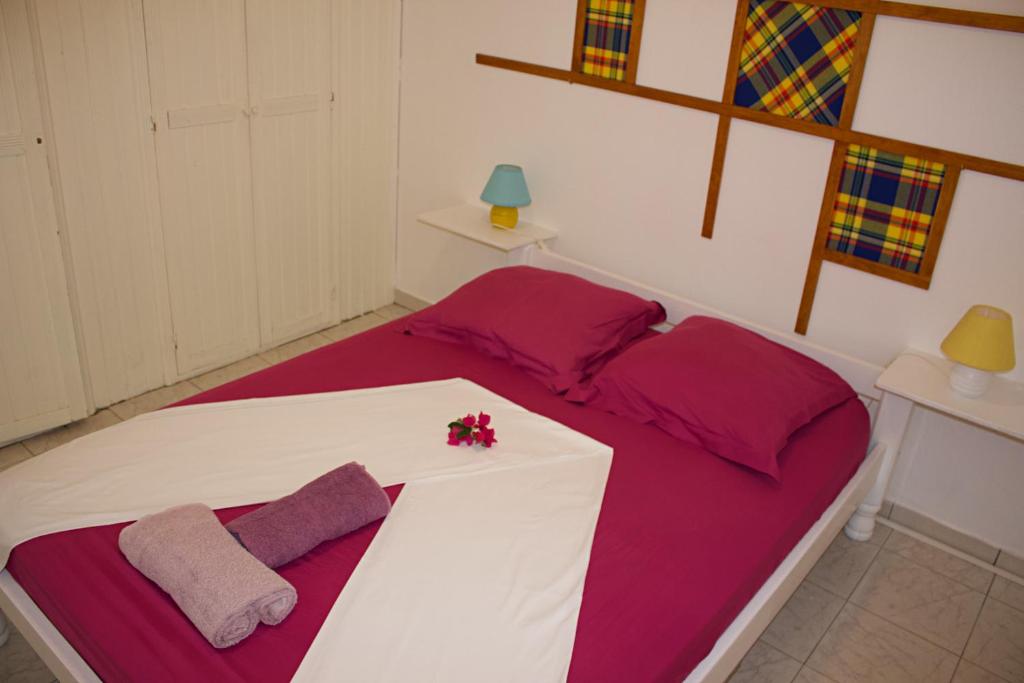 Postel nebo postele na pokoji v ubytování Domaine Macabou