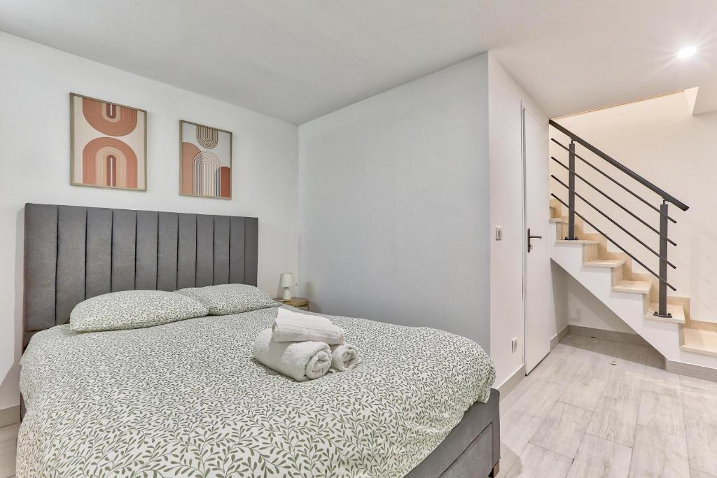- une chambre blanche avec un lit et un escalier dans l'établissement Magnifique appartement proche de Paris, à Villejuif