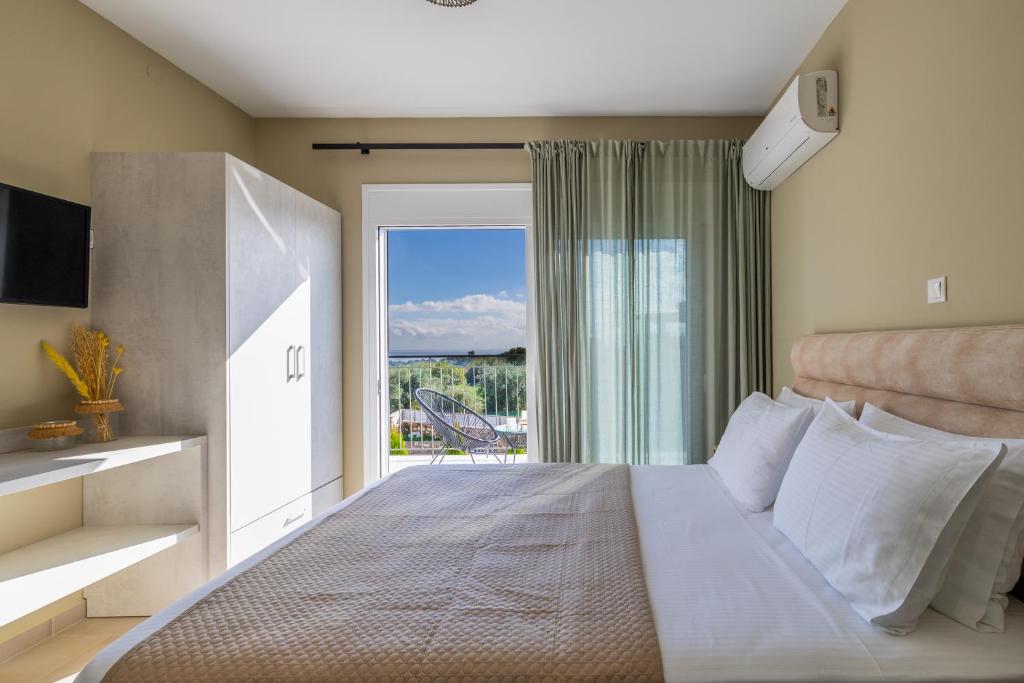 a bedroom with a large bed and a balcony at Taras Residence in Karavádhos
