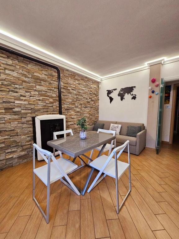 a dining table and chairs in a living room at Oasi di Greta Suite Home - Fiumicino in Fiumicino