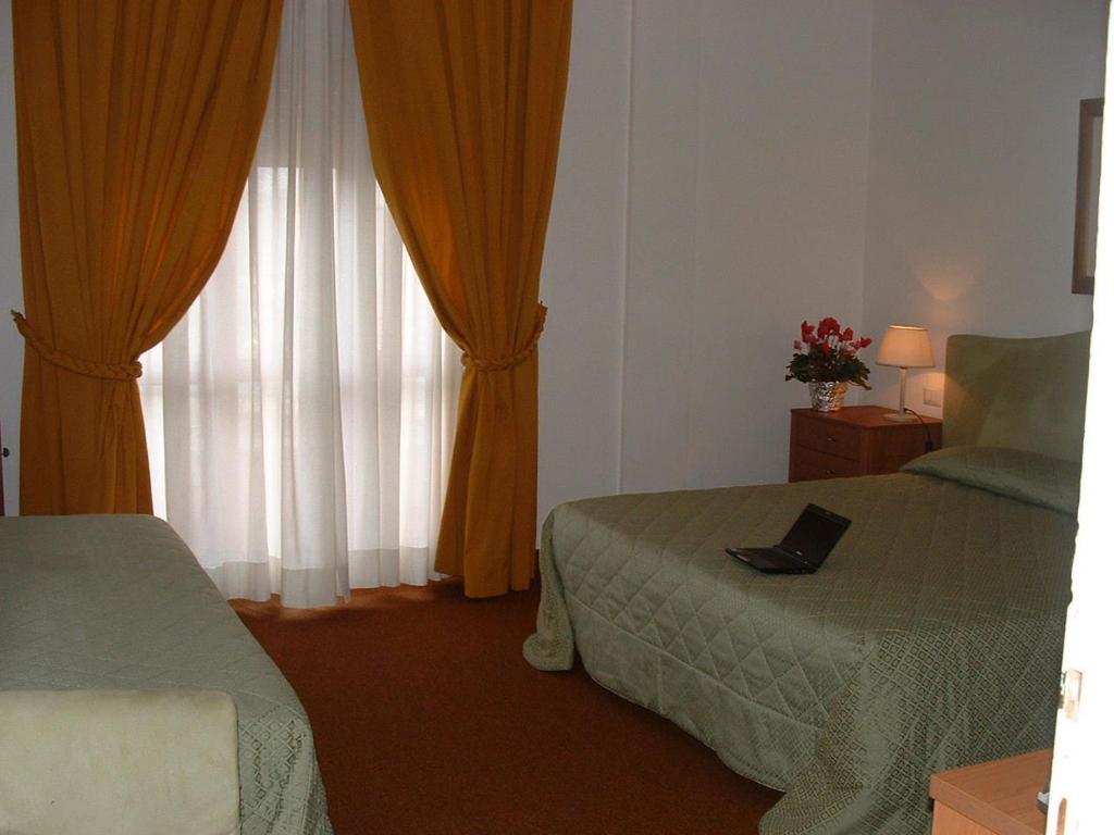 Postel nebo postele na pokoji v ubytování Hotel Barberino