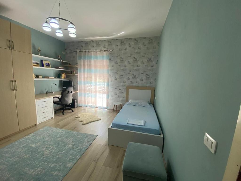 a small bedroom with a bed and a desk at Luxury House in Shkodër