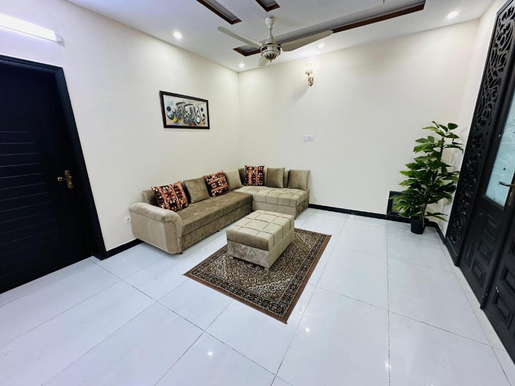 a living room with a couch and a table at Kashees Lodges in Islamabad
