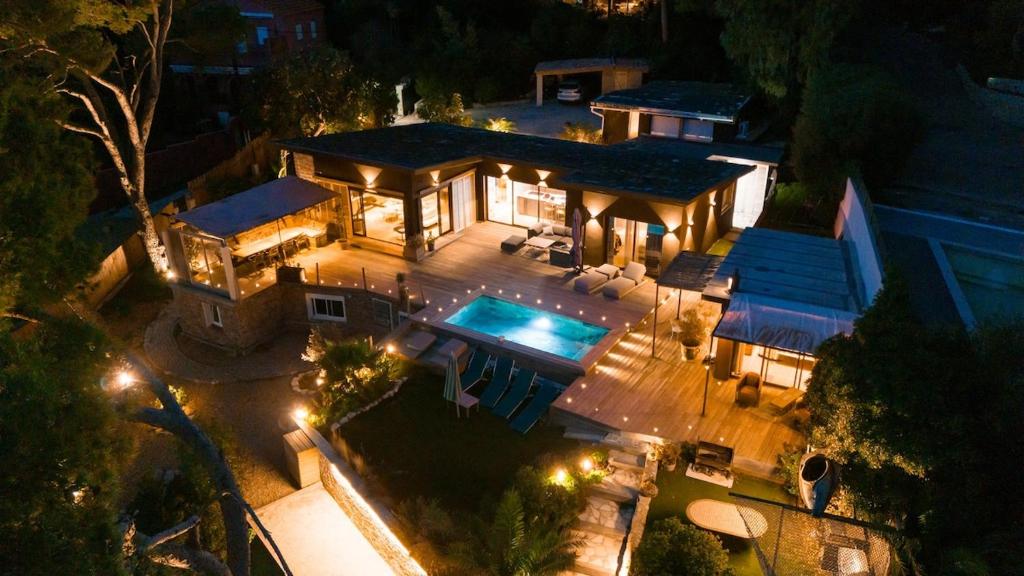 an aerial view of a house with a pool at night at Luxueuse villa bord de mer in La Seyne-sur-Mer