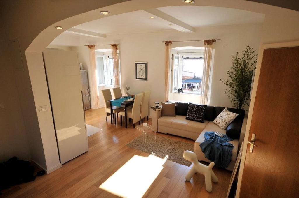 ein Wohnzimmer mit einem Sofa und einem Tisch in der Unterkunft Apartment Flower in Dubrovnik