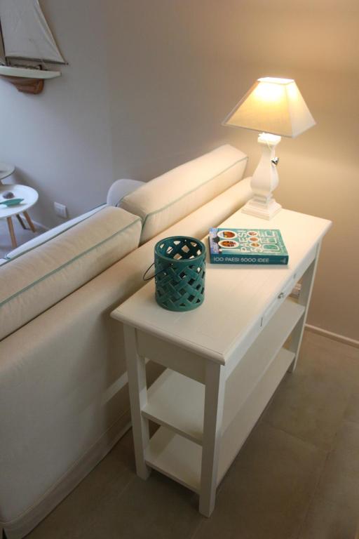 a table with a lamp on top of a couch at Clara's House in Portofino