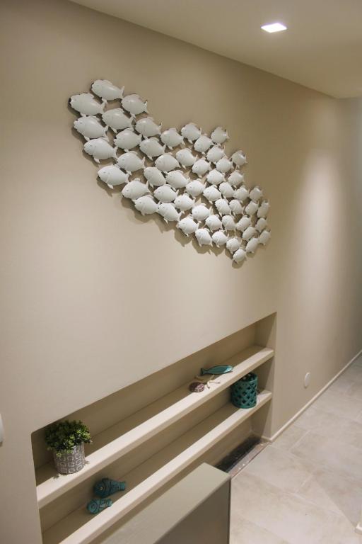 a wall with a heart made out of plates on a wall at Clara's House in Portofino