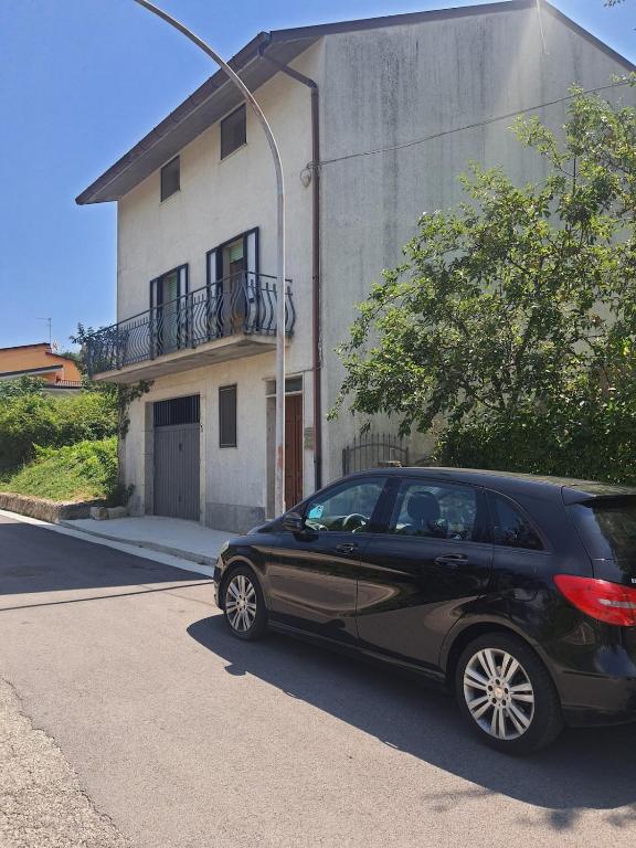 a black car parked in front of a house at Artemide Residence Acquaviva in Acquaviva dʼIsernia
