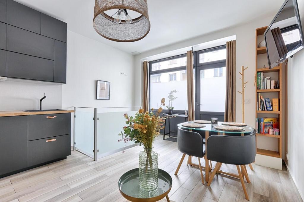 une cuisine et une salle à manger avec une table et des chaises dans l'établissement Paris Montmartre Sacré Cœur Superb Duplex, à Paris