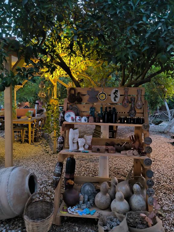 a display of vases and other items on a table at Litost Cafe in Adrasan