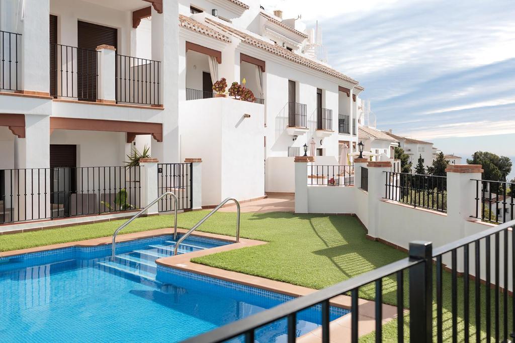 a view from the balcony of a house with a swimming pool at Casa Ilusión in Frigiliana
