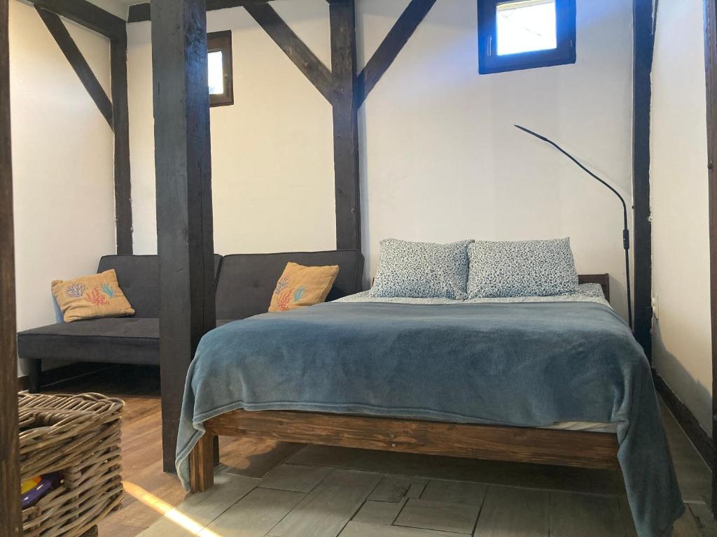 a bedroom with a bed with a blue comforter at Csónakház in Tiszadob