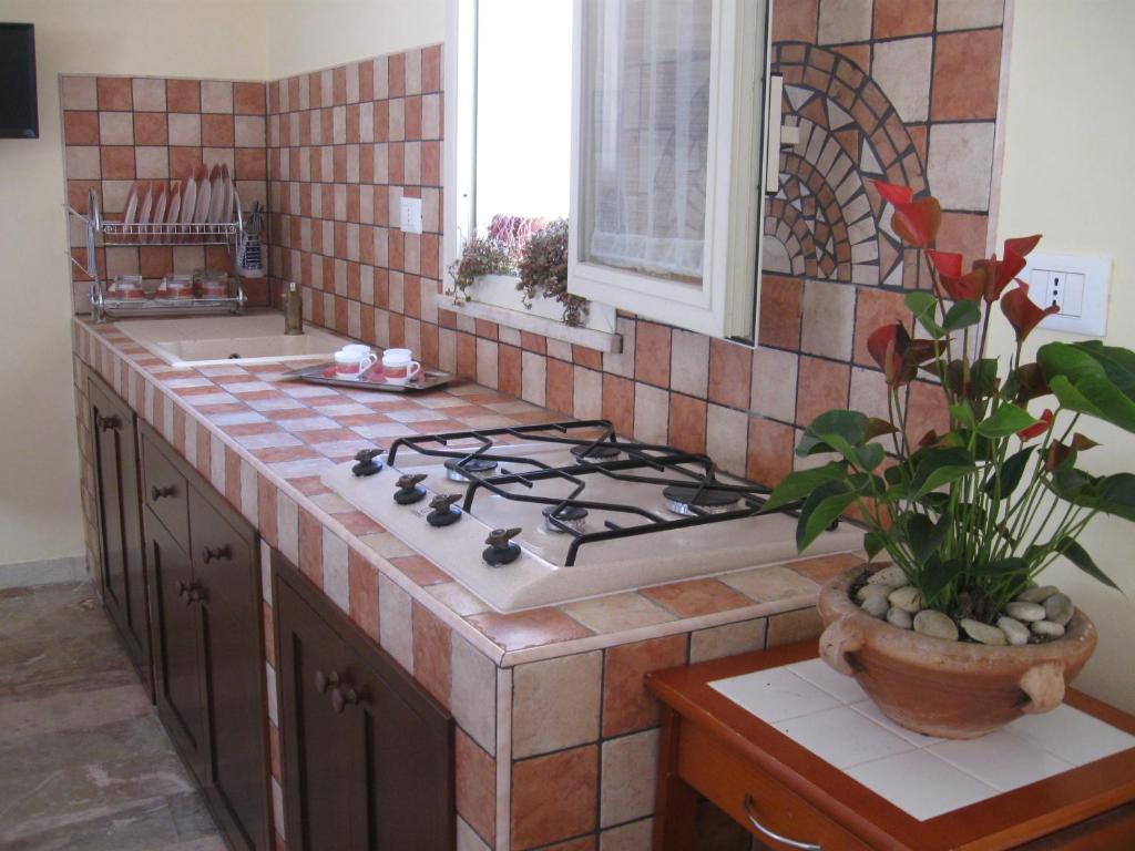 a kitchen with a stove and a counter top at VALDERICE VACANZE biker's friend in Valderice