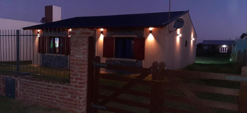 a small brick house with lights on it at night at Casa la 12 in Miramar