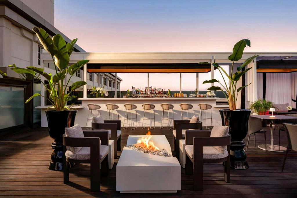 a patio with a fire pit on a roof at SLS Hotel, a Luxury Collection Hotel, Beverly Hills in Los Angeles