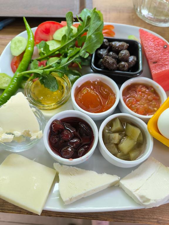 a tray with different types of cheese and other foods at Litost Cafe in Adrasan