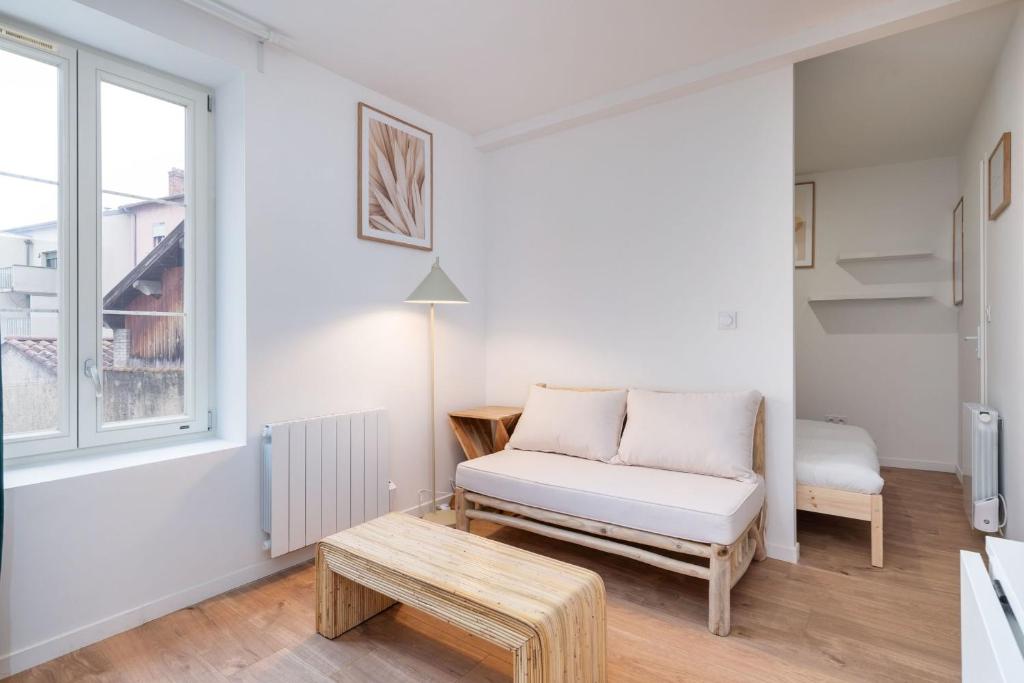 a living room with a couch and a table at Apartment Perron - Cozy 2 people - Oullins in Oullins