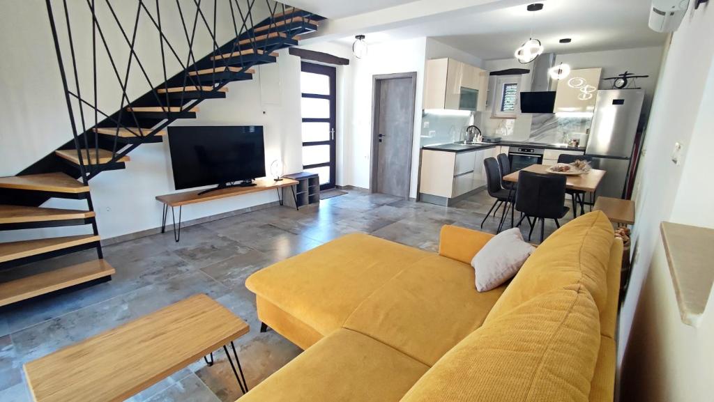 a living room with a couch and a kitchen at Holiday home Brseč in Mošćenička Draga