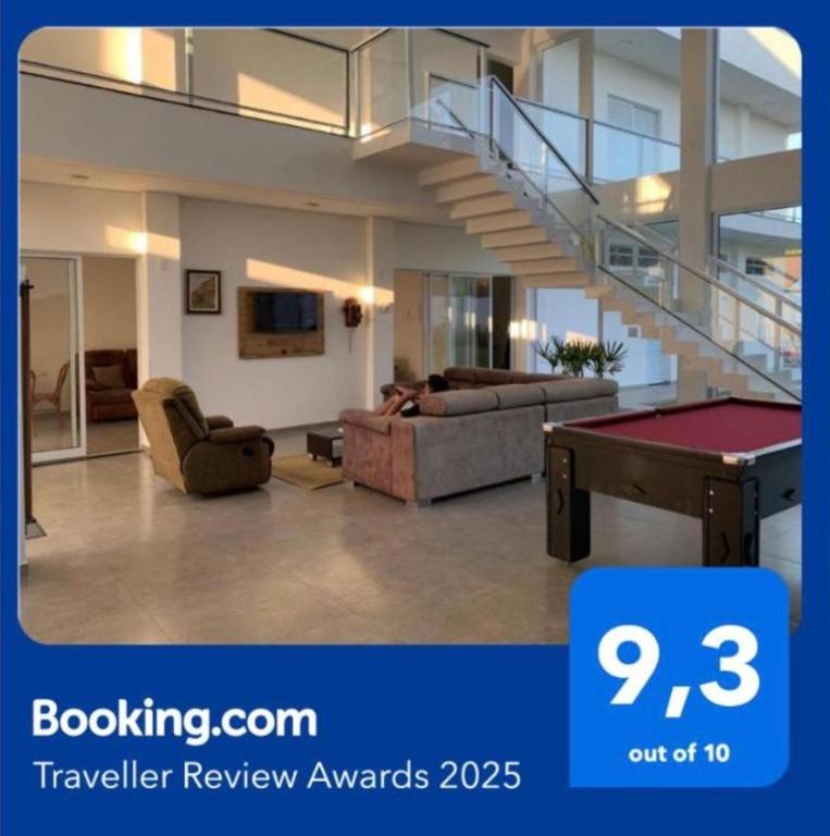 a view of a living room with a pool table at Hospedaria Colinas in Indaiatuba