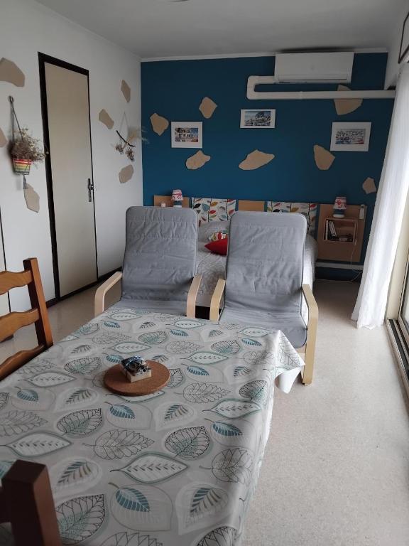 - une chambre avec un lit et deux chaises avec une plaque de cuisson dans l'établissement relax curiste, à Gréoux-les-Bains