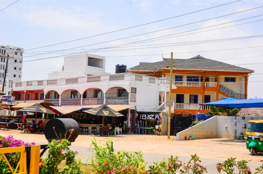 a street scene with a building and a market at Lifestyle 3 Shanzu 2 bedroom furnished Apartment in Mombasa