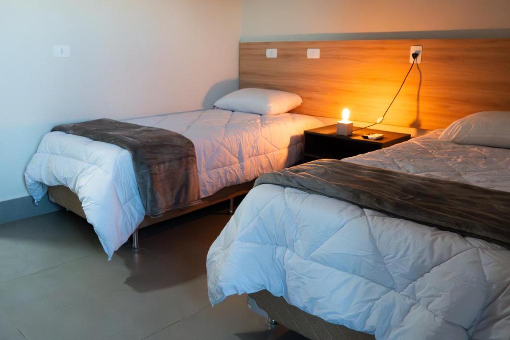 Postel nebo postele na pokoji v ubytování Dicopi Hotel