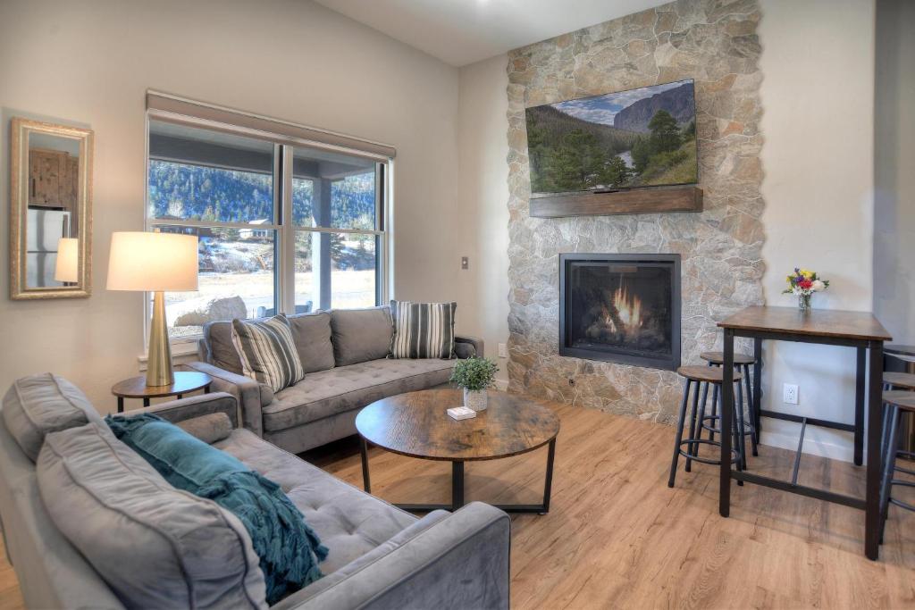 a living room with a couch and a fireplace at Vista355A in South Fork