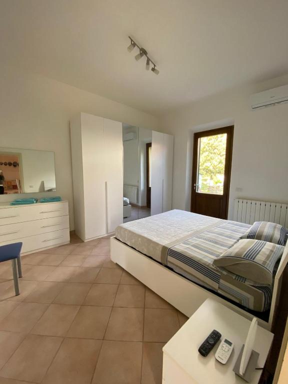 a large bedroom with a bed and a table at Villa La Pila Bilo in Marina di Campo